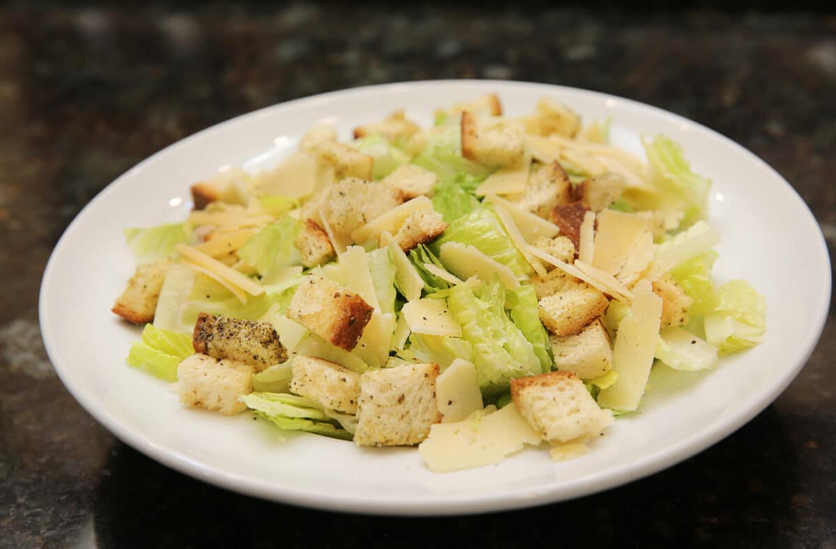 Classic Caesar Salad featuring chopped romaine, shaved parmesan cheese, and house-made croutons.