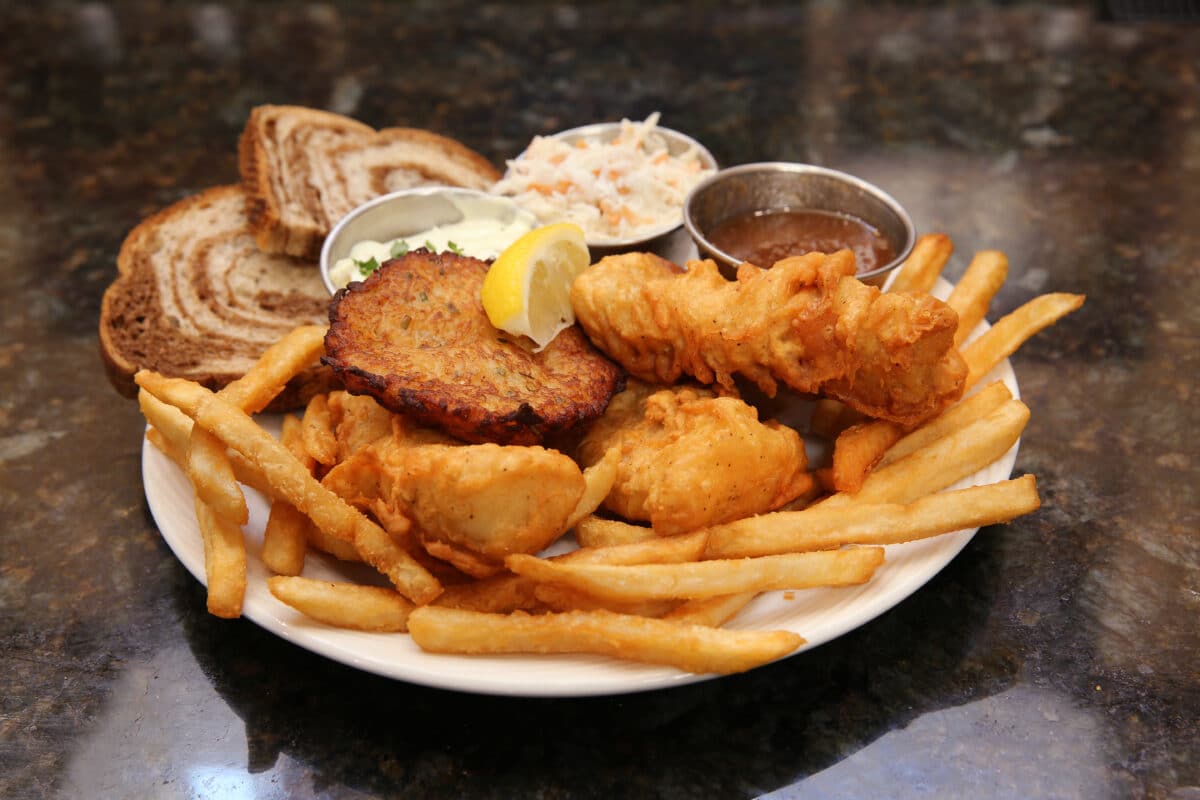 Traditional Wisconsin Fish Fry plate featuring battered white fish, fries, rye bread, coleslaw, and tartar sauce at Tavern at Park.